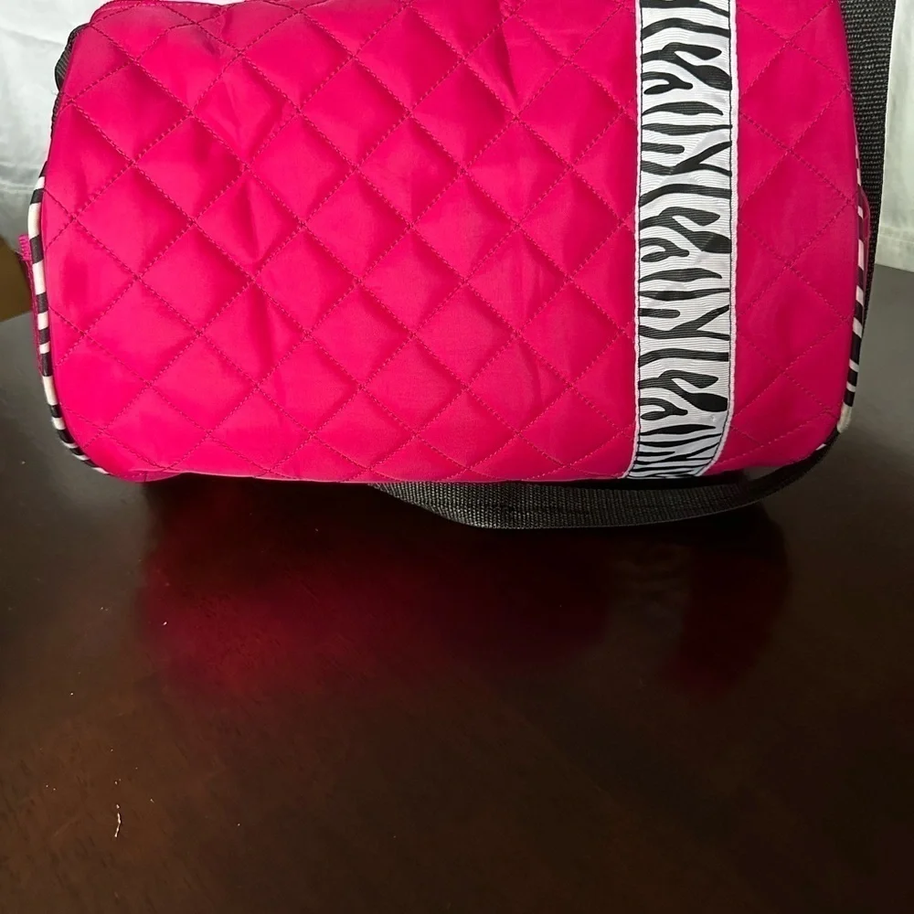 Pink dance bag with zebra print accent.